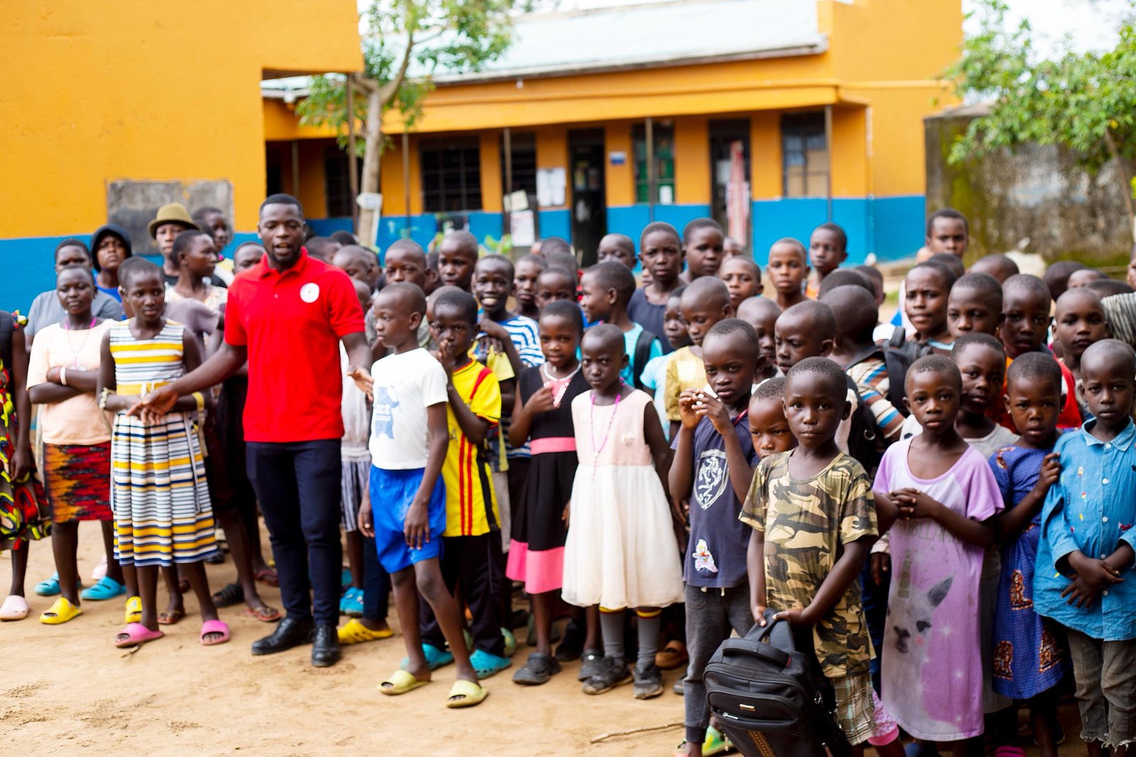 Children laughing together outside their safe and warm dormitory at the foundation